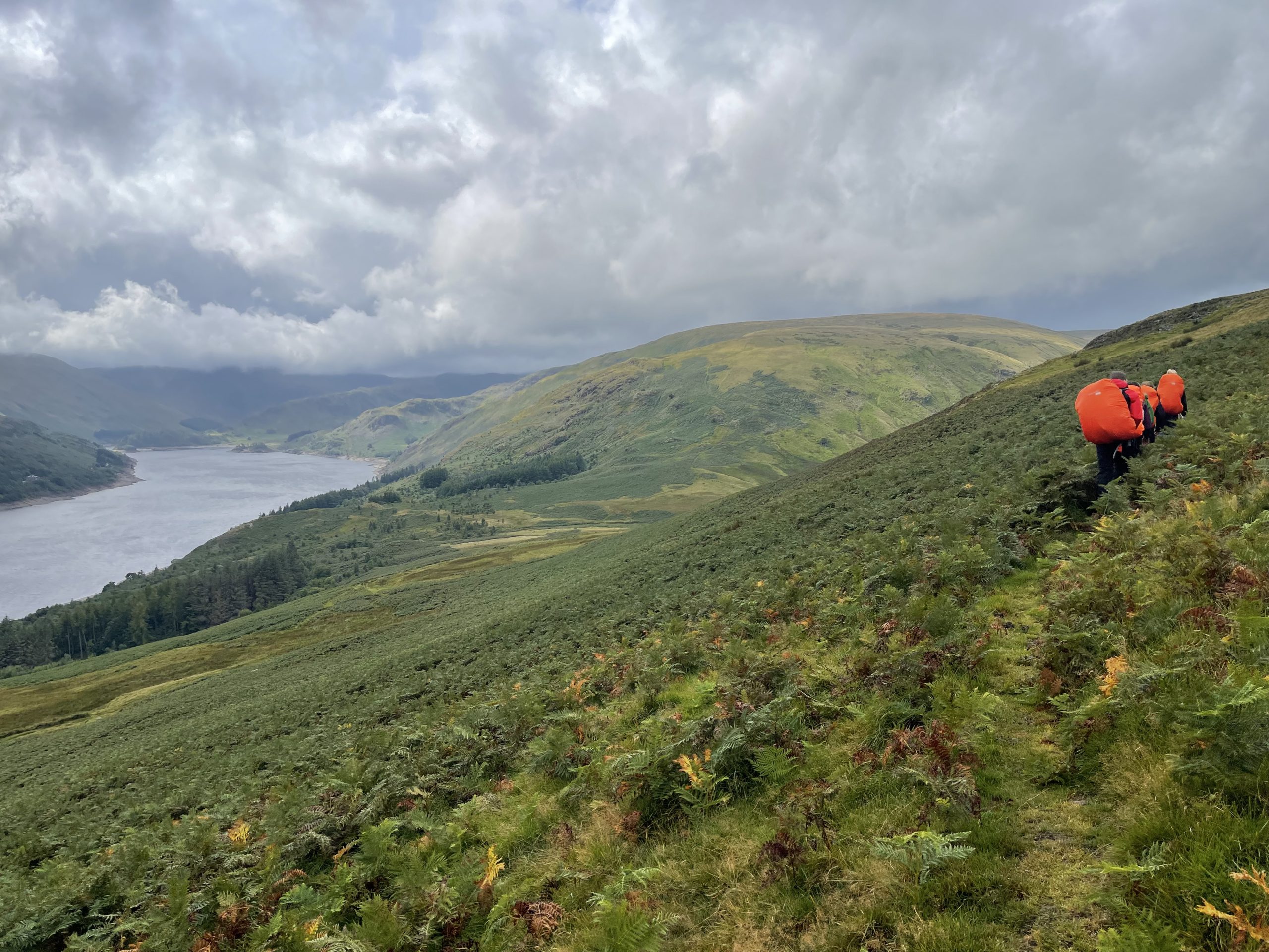 A group of Whitley Bay Explorer Scouts hiking past a lake