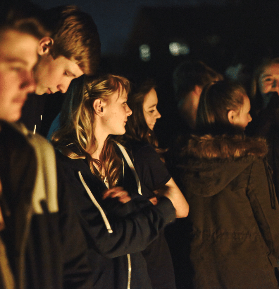 Explorer Scouts socialising by a campfire
